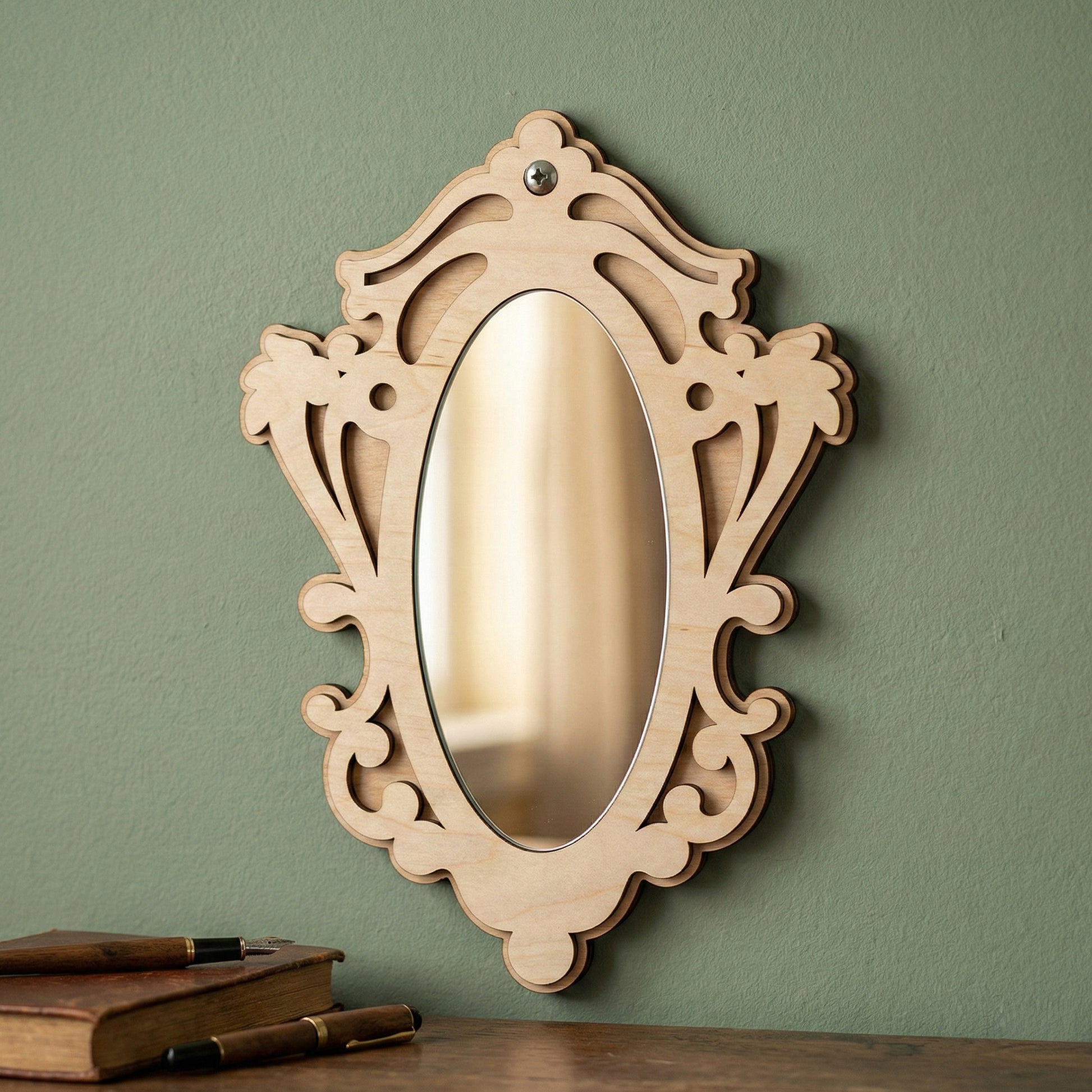 Elegant laser cut wooden Mirror ornaments with a curved frame design, set against a green wall background.
