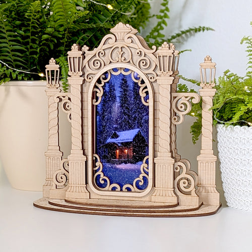 Laser cut Christmas Mirror Phone Stand with holiday motifs.