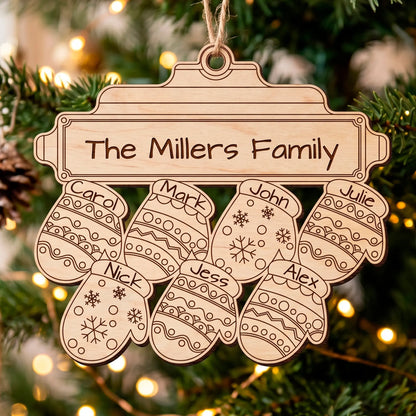 Laser cut plywood Christmas ornament shaped like a mitten with snowflake patterns and small family name plates.