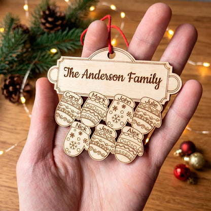 Close up of a laser cut plywood family ornament in a hand, showing 7 engraved mittens under "The Anderson Family" sign.