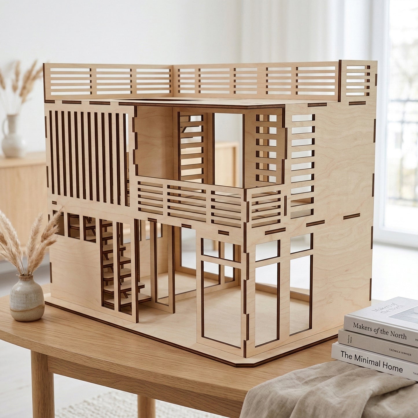 Side view of a contemporary dollhouse made of laser cut plywood. Shows the architectural slatted balcony and large window openings. The smooth wood texture and dark edges emphasize the modular, minimalist design of the toy house.