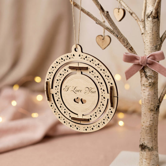 Angled shot of a handcrafted wooden Valentine's gift hanging on a birch-style branch with a pink velvet bow. The plywood ornament showcases precise laser-etched details and heart motifs. Styled in a warm, aesthetic environment with soft ambient lighting.