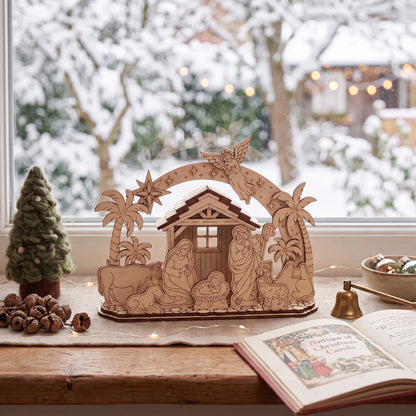 Laser cut plywood Christmas nativity scene on wooden window sill with snow outside and carol book
