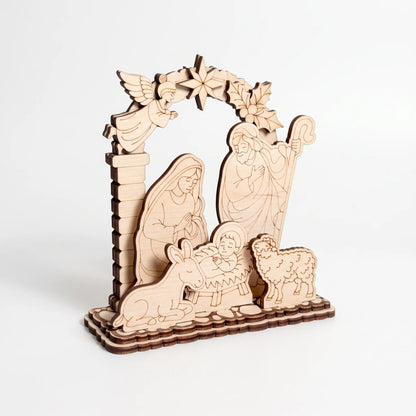 Perspective shot of multi-layer laser cut plywood Christmas nativity ornament on clear white backdrop.