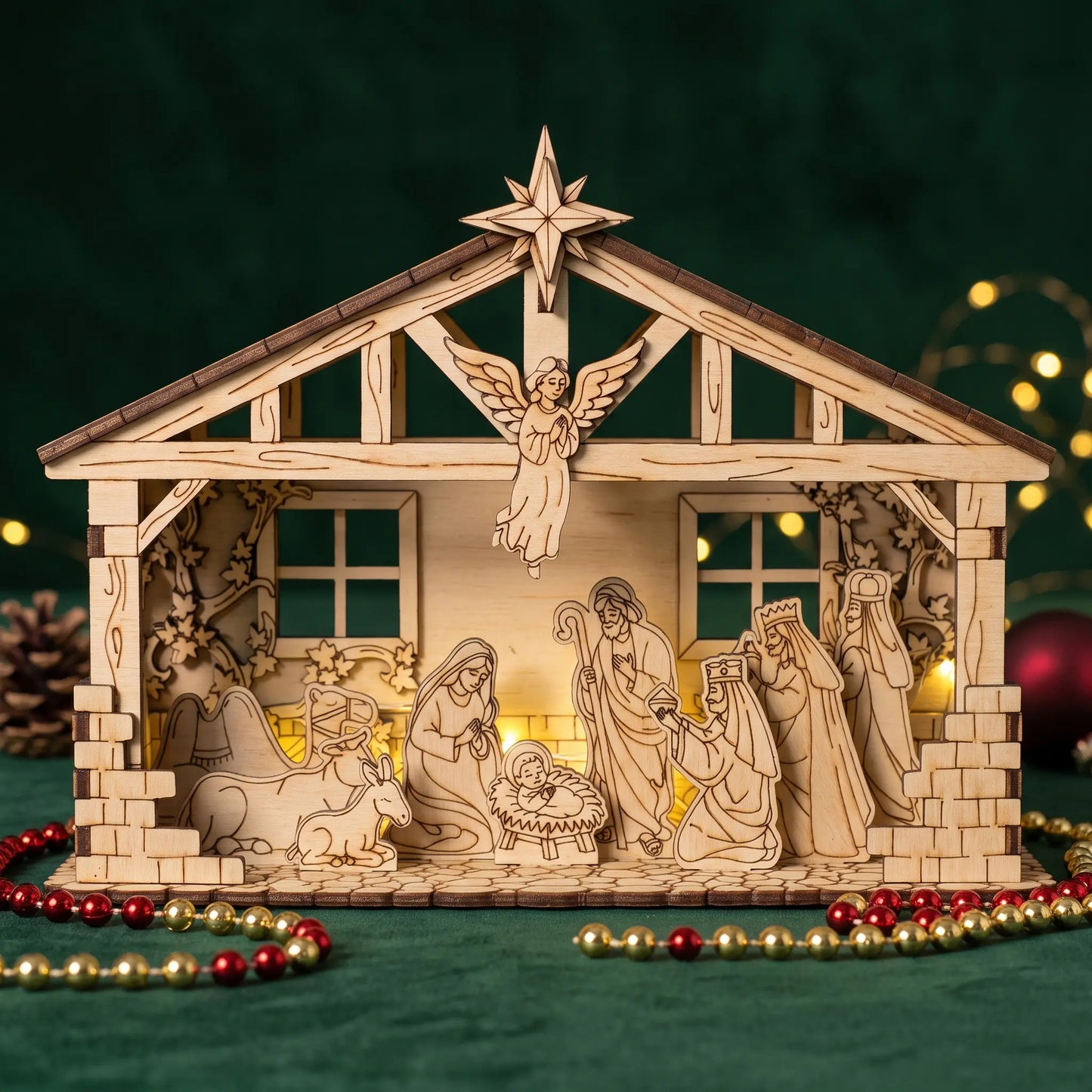 A wooden nativity scene display with laser-cut figures and a stable structure