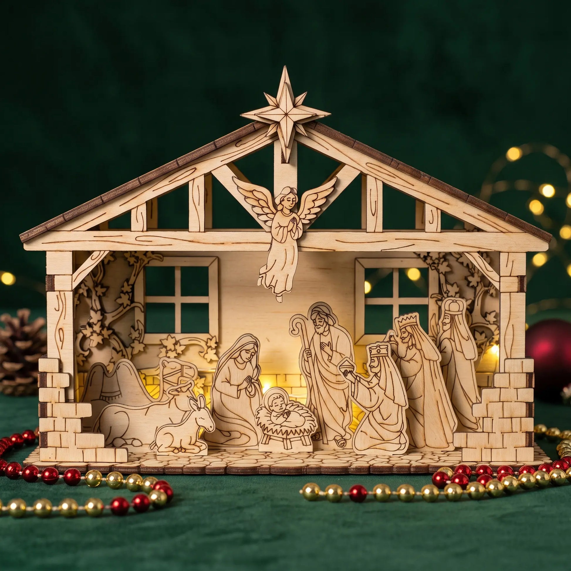 A wooden nativity scene display with laser-cut figures and a stable structure