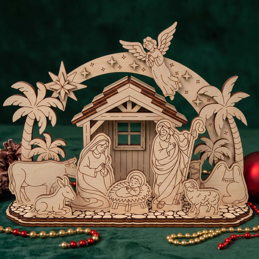 Laser cut plywood nativity set on green fabric with palm trees, angel arch, and holiday beads.