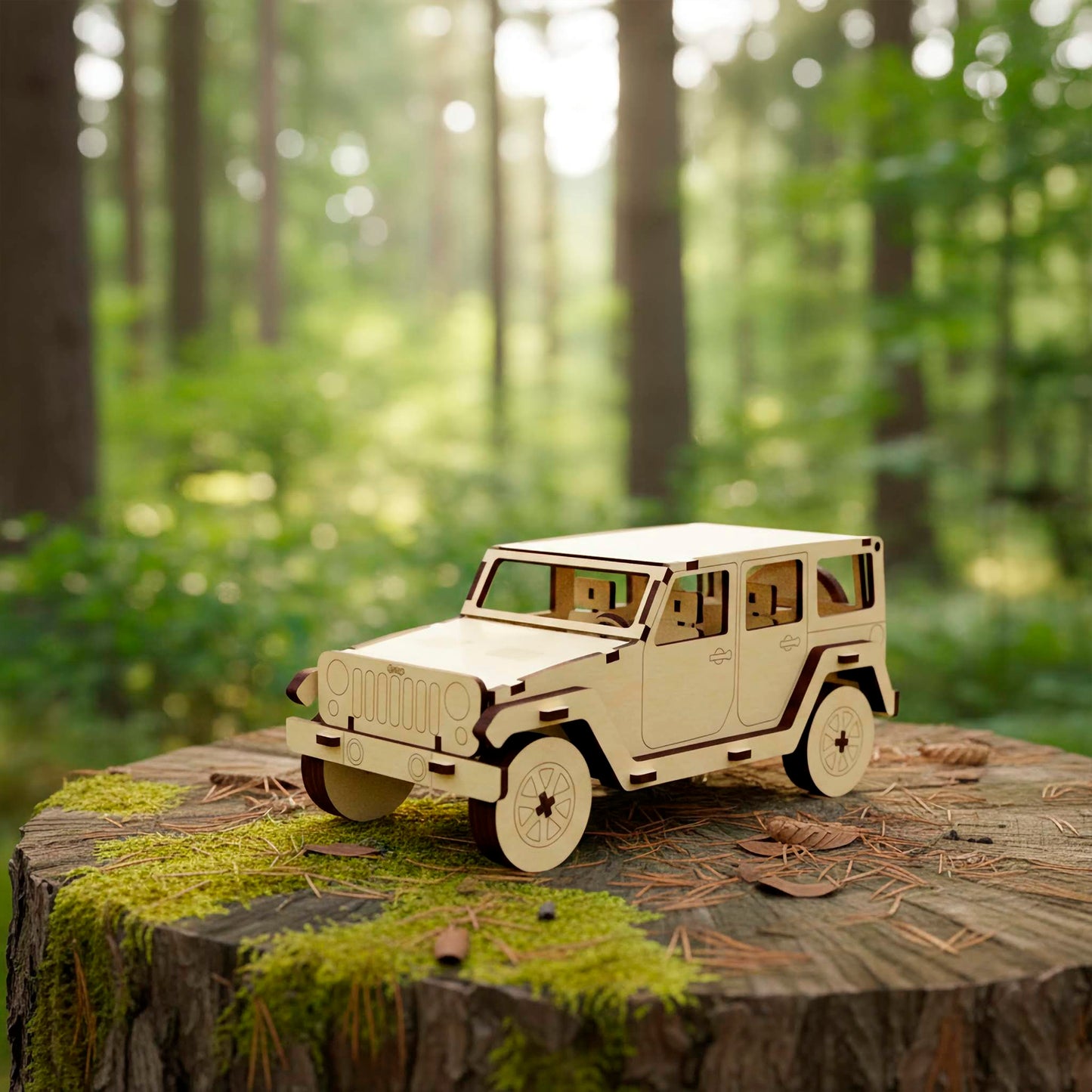 Front three-quarter view of a laser cut plywood wooden 4x4 vehicle model. Shows the iconic vertical grille, headlights, and layered fender flares. The model sits on a mossy tree stump in a bright, blurry woodland setting.
