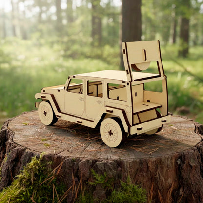 Rear view of a laser cut wooden plywood off-road SUV model on a tree stump. The trunk is open, showing the interior structure. Fine dark edges from laser cutting highlight the doors and spare wheel mount. Forest background.