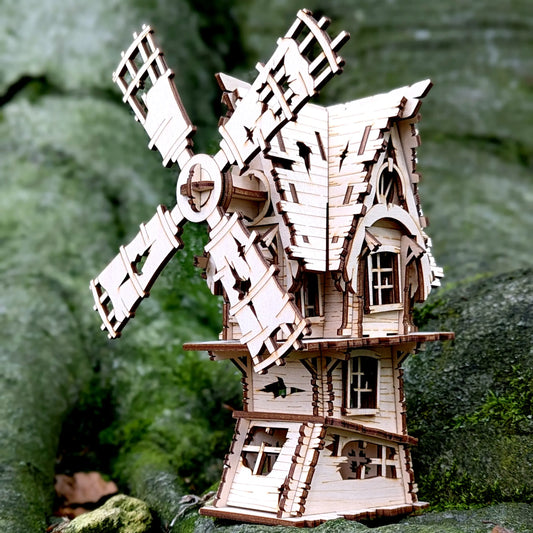 A beautiful straight eye-level front look at an assembled miniature spooky village windmill built of laser cut plywood lines.