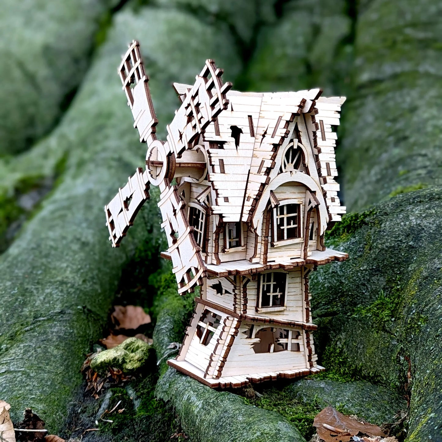 A lovely side profile shot highlighting the creepy fence and window details of a spooky halloween laser cut plywood windmill.