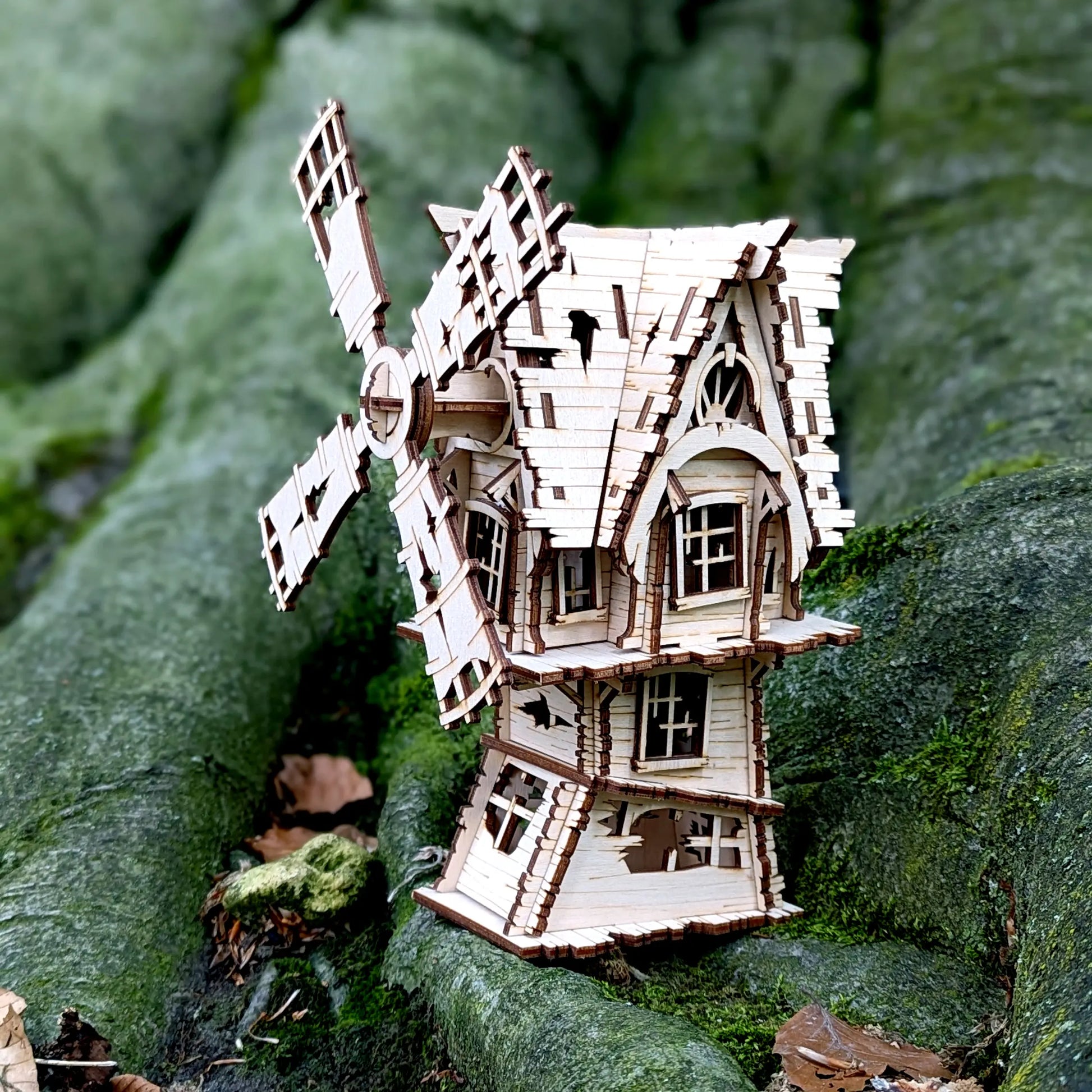 A lovely side profile shot highlighting the creepy fence and window details of a spooky halloween laser cut plywood windmill.