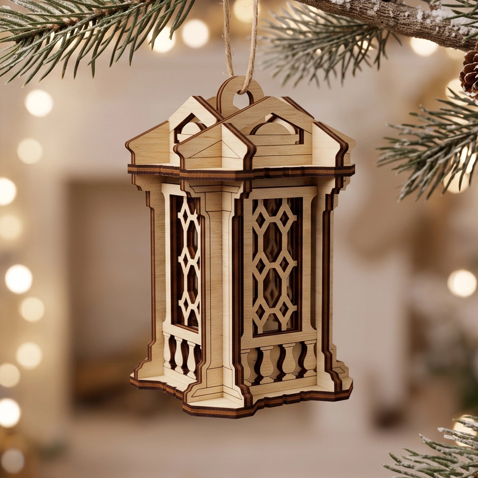 Laser cut plywood lantern ornament hanging from a pine branch, with a soft blurred holiday light background.