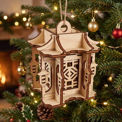 Laser cut plywood Asian pagoda lantern ornament hanging from a festive Christmas tree branch, next to holiday baubles.