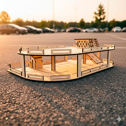 Two-story laser cut wooden plywood toy parking garage at sunset. Features ramps, safety railings, and a small elevator house. Precision-cut plywood assembly set displayed on asphalt with real cars blurred in the background.