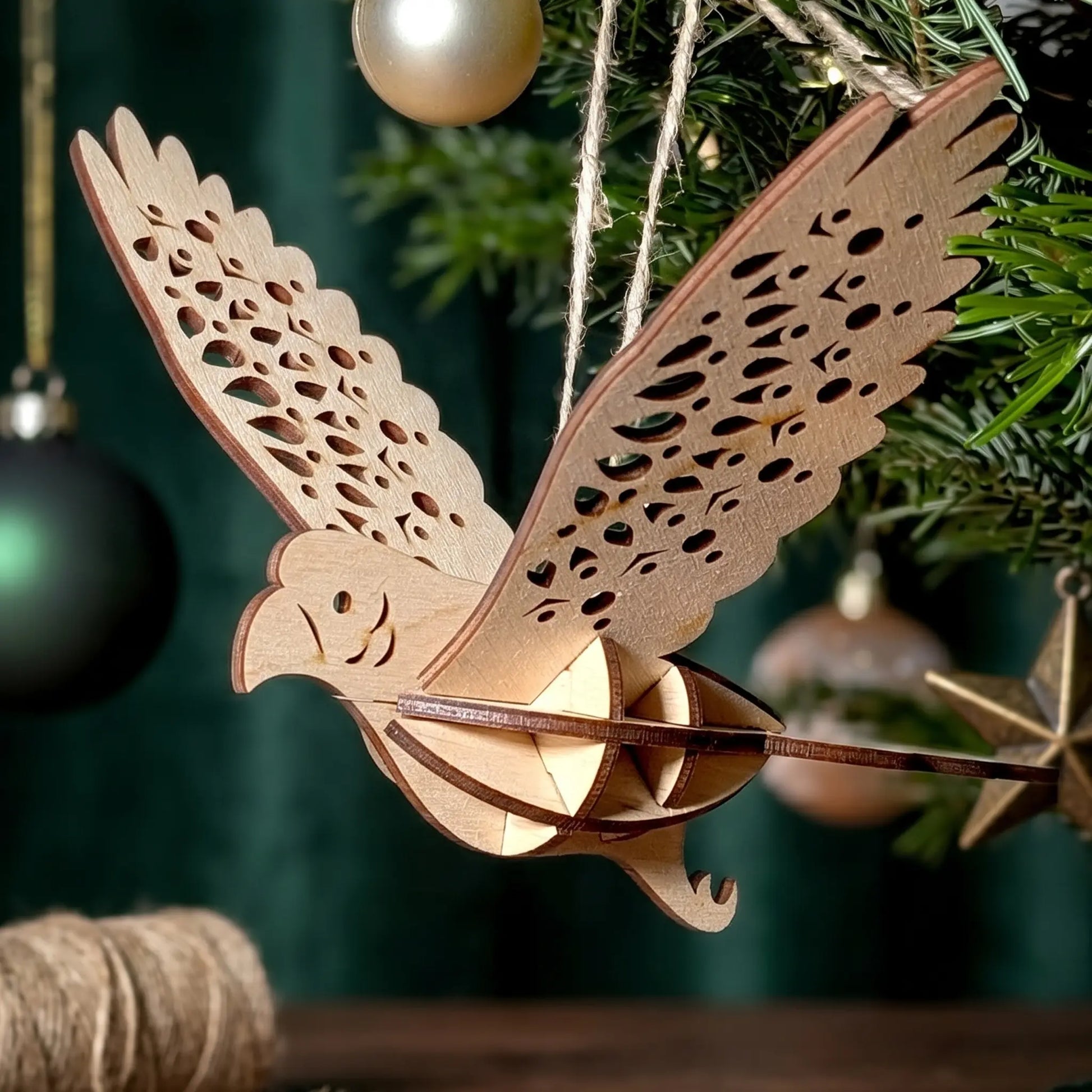 Wooden parrot laser cut ornament hanging on a Christmas tree with green background
