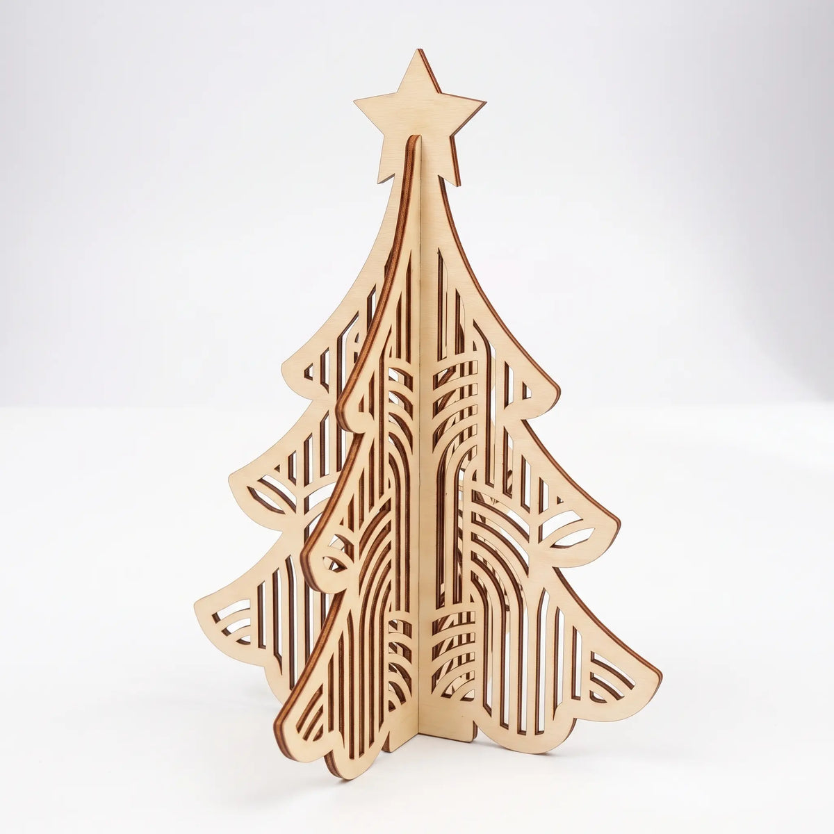 Art deco 3D laser cut plywood Christmas tree figurine with vertical striped arch cutouts and top star on white background.