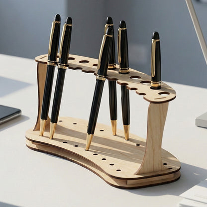 Minimalist laser cut plywood pen stand with a double-deck arc design. Features ten circular slots to hold pens vertically. Shown on a white office desk with black and gold pens, a smartphone, and documents to demonstrate scale.