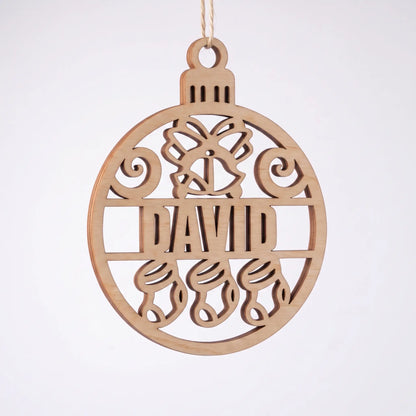 Front view of laser cut plywood David name bauble ornament with bell and stockings cutouts on plain white surface