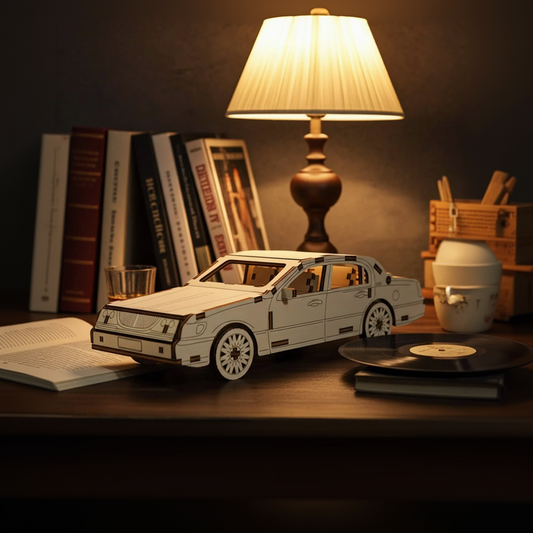 Laser cut wooden plywood luxury sedan 3D model on a wooden desk next to a vintage lamp and vinyl records. Detailed plywood assembly featuring a classic grille, multi-spoke wheels, and realistic door handles. Warm evening atmosphere with bokeh lights.