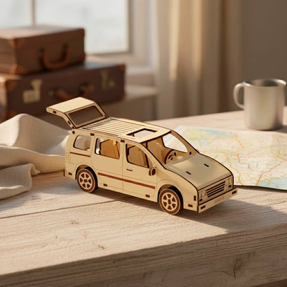 Laser cut wooden  plywood model with an open rear trunk and sunroof. Detailed plywood 3D puzzle on a wooden desk with a map and travel mugs. Shows precision-cut interior seats and steering wheel with dark burnt edges on light wood