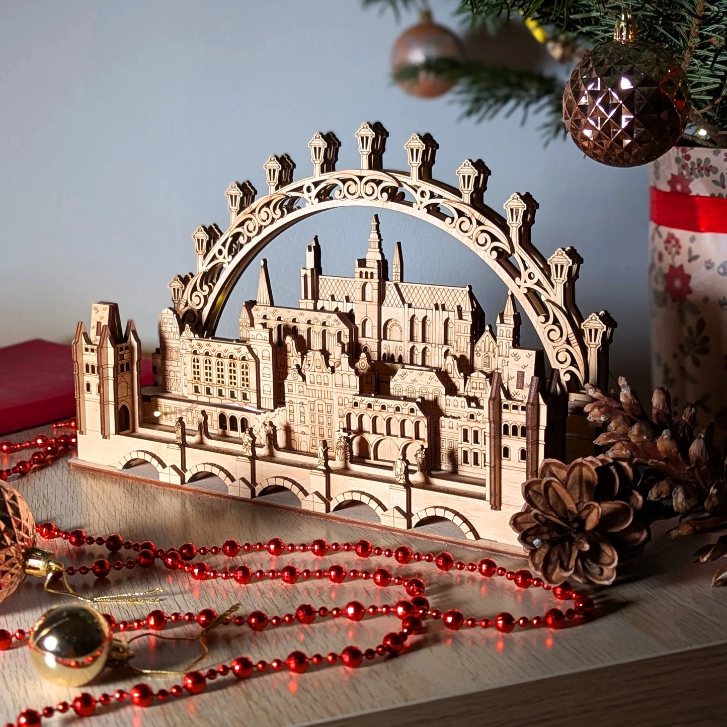 Beautiful angled side view highlighting the intricate layered depth of a miniature 3D Prague cityscape in laser cut plywood