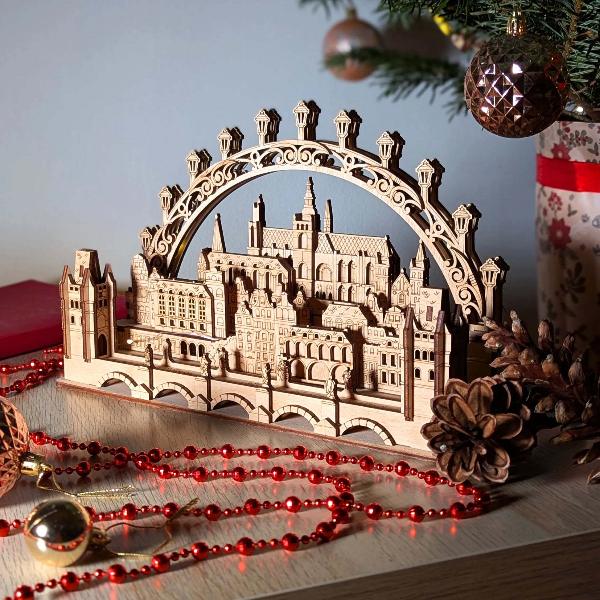 Beautiful angled side view highlighting the intricate layered depth of a miniature 3D Prague cityscape in laser cut plywood