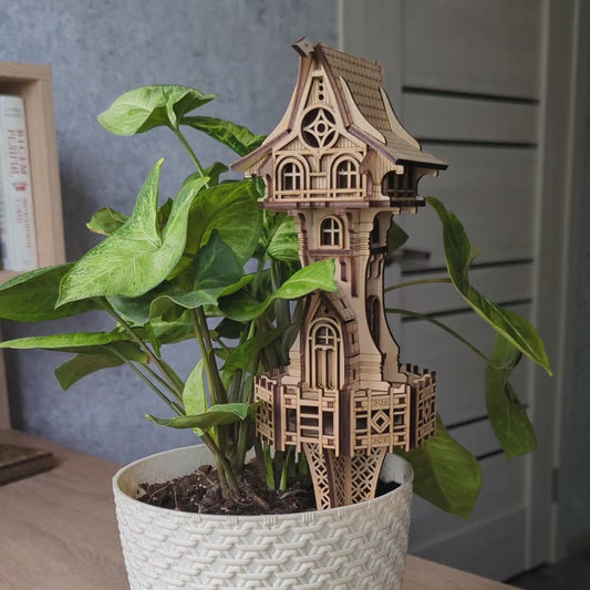 Laser cut plywood miniature fairy tower decorated with dark brown engraved accent lines.