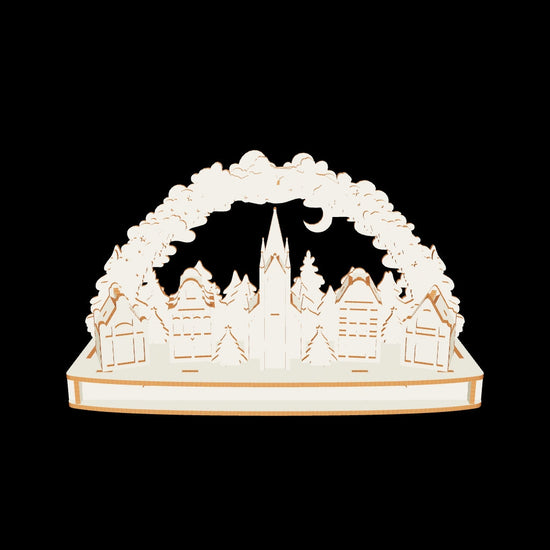 Detailed 3D Christmas town arch with Santa sleigh, houses, and trees made from laser cut plywood on a clear white background.