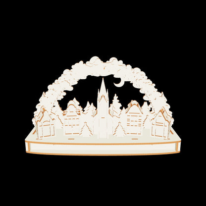 Detailed 3D Christmas town arch with Santa sleigh, houses, and trees made from laser cut plywood on a clear white background.