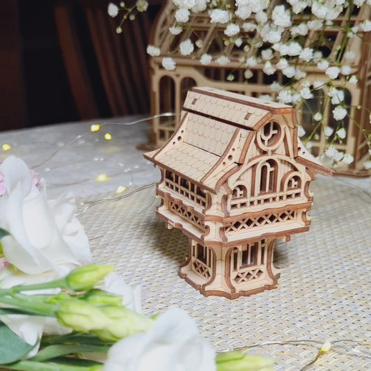 Charming miniature gnome house crafted from laser cut plywood, perfectly staged with soft floral decor and warm accents.