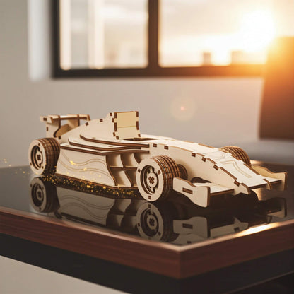 Laser cut wooden plywood formula racing car 3D model on a reflective black table. Detailed plywood assembly showing aerodynamic wings, wide treaded tires, and open cockpit. Urban sunset city skyline through a large window in the background.