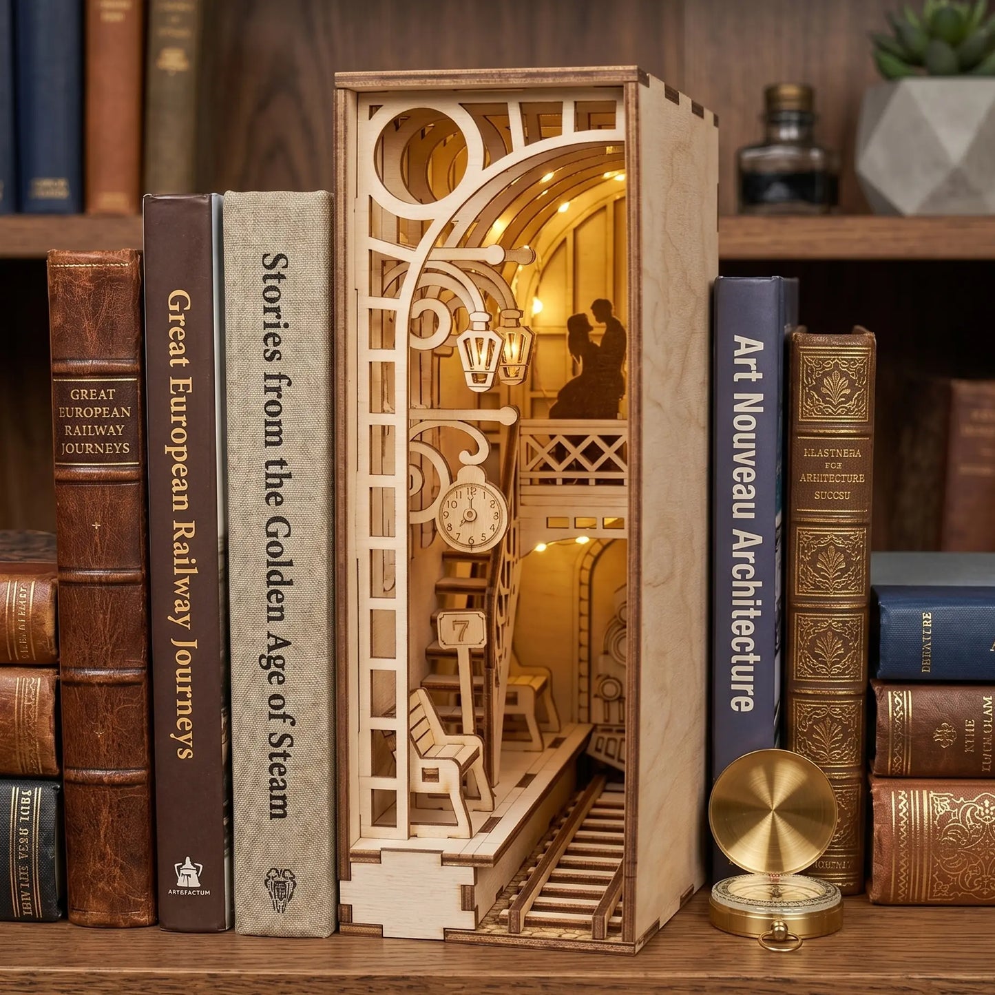 Wooden laser cut model of a railway station with books on a shelf