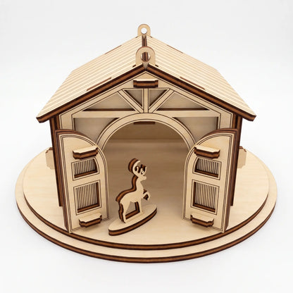 Front view of laser cut plywood reindeer stable with open arched double doors and small standing deer on round base