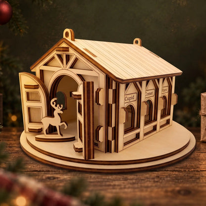 Laser cut plywood reindeer barn with open front doors and engraved feeding stalls on dark wood festive tabletop