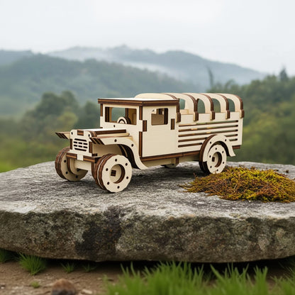Laser cut wooden plywood safari truck model with intricate layered details and curved roof ribs. The 3D assembly toy is displayed on a natural stone with moss, set against a scenic, misty mountain and forest background.