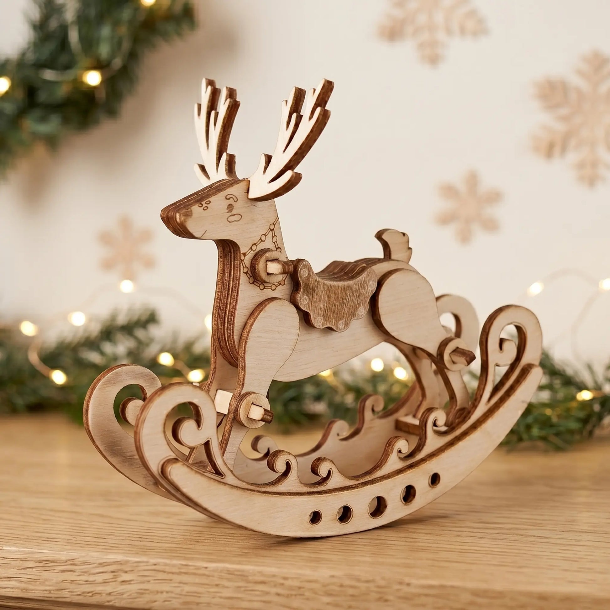 Wooden reindeer laser cut model on a wooden surface with a festive background
