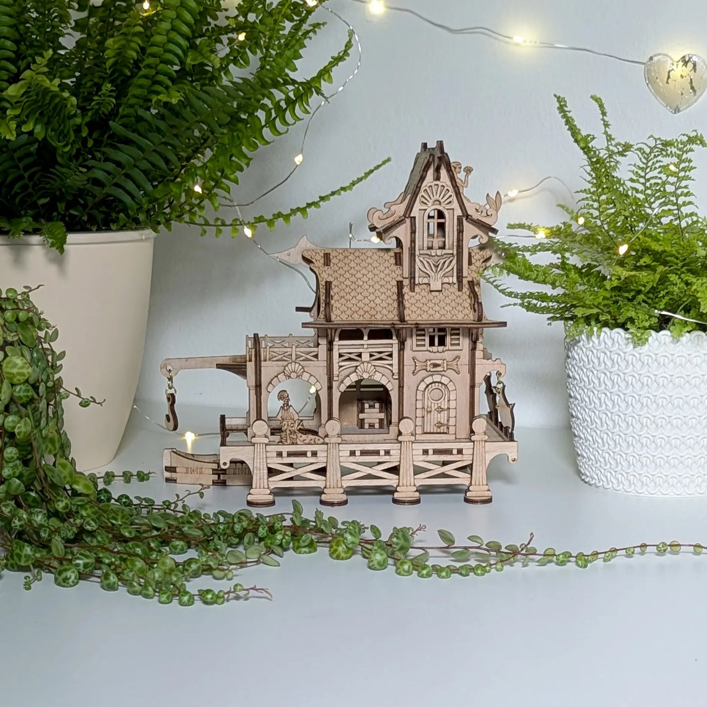 Beautiful straight eye-level front look at a miniature sea lighthouse building puzzle built of laser cut plywood.