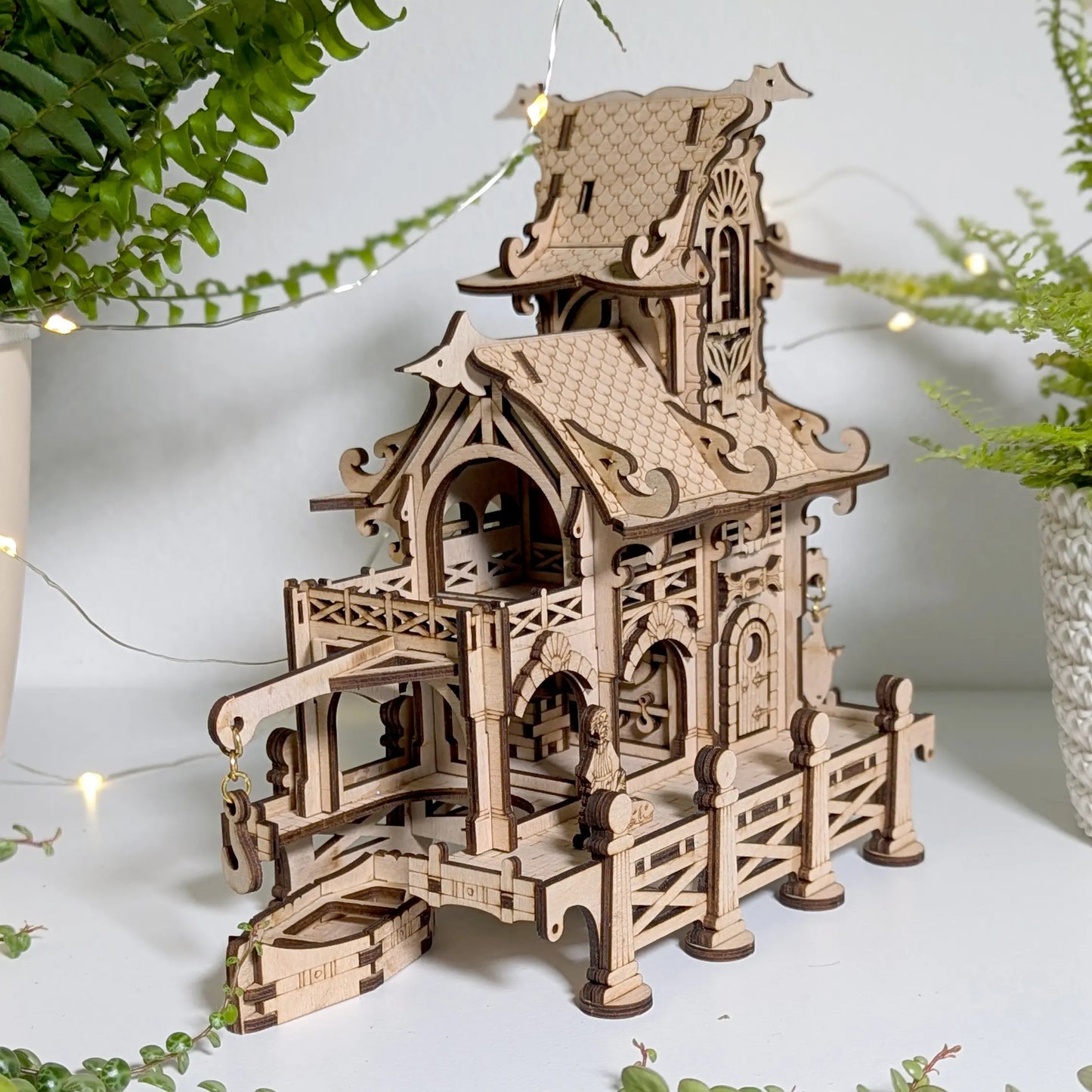 Angled perspective close product shot of an assembled sailor townhouse model made from layered laser cut plywood.