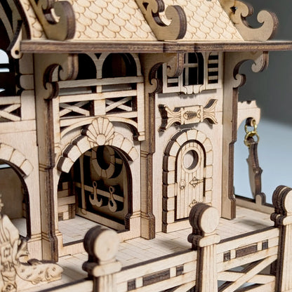 A straight side profile view highlighting the clean interlocking tabs of a mini marine house of laser cut plywood.