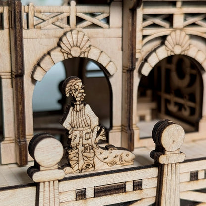 Tighter angled profile view showcasing the detailed nautical window frame structures of a laser cut plywood house.