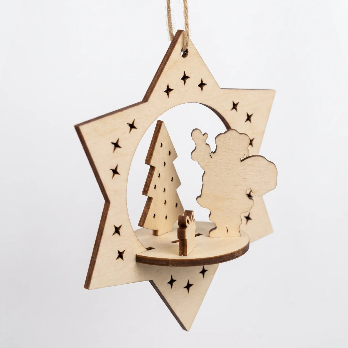 Side-angle view of hanging 3D laser cut plywood holiday star bauble with miniature Santa scene on plain white.