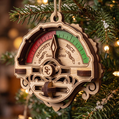 Side view of laser cut plywood Santa meter ornament hanging on pine tree branch with needle pointing to center.