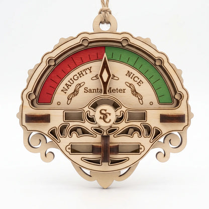 Direct front view of laser cut plywood Santa meter ornament with red and green gauge on plain white background.