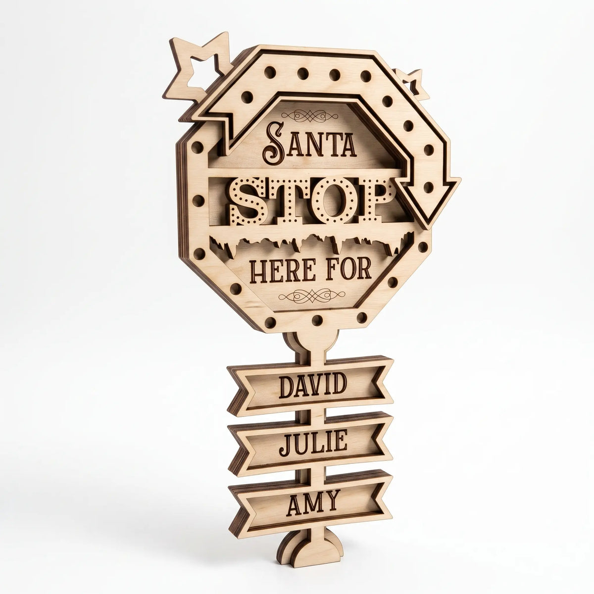 Natural unpainted laser cut plywood Santa Stop Here sign with tiered name ribbons, freestanding on a white backdrop.