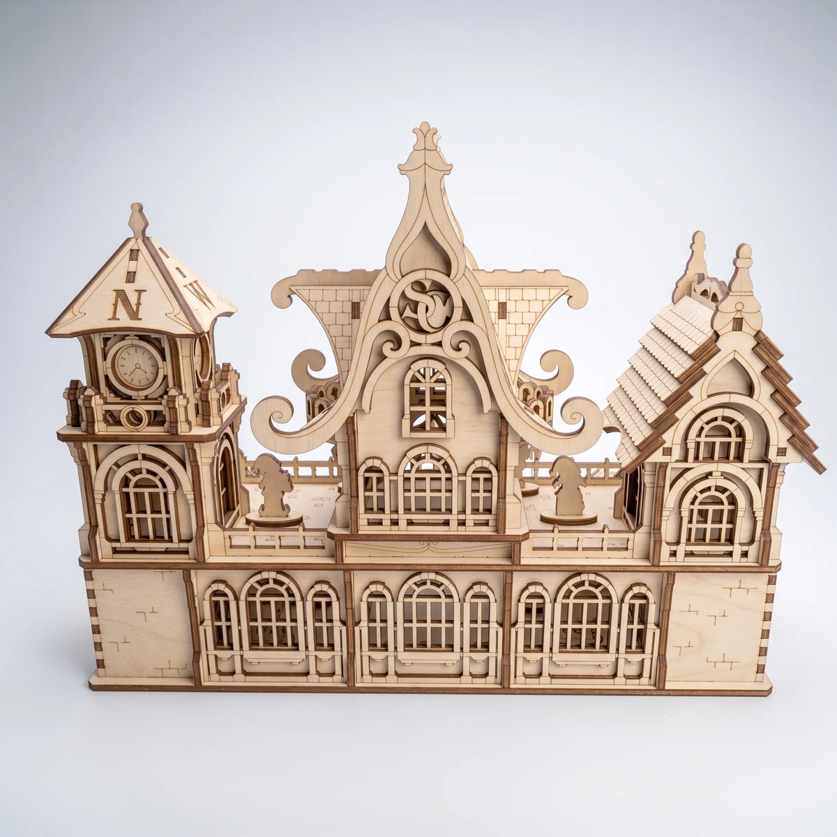 Rear view of laser cut plywood Santa workshop mansion on plain background showing back windows wall.