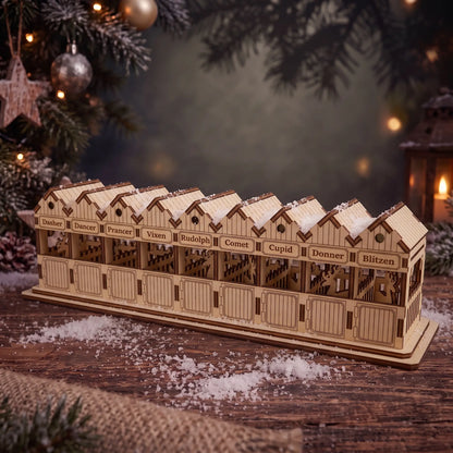 Cozy holiday setting with a laser cut plywood reindeer barn near a Christmas tree and glowing lantern.