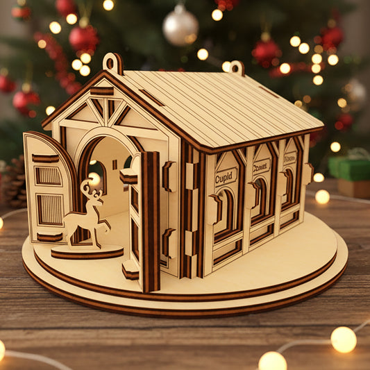 Laser cut wooden Santa's Reindeer Barn ornament with a reindeer peeking through the open door and labeled stalls for Comet, Cupid and Vixen, placed against a twinkling Christmas tree lights background.