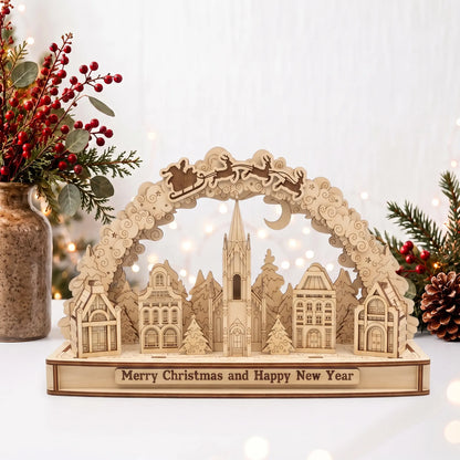 Laser cut plywood Christmas village arch diorama with Santa sleigh above church, red berries, and warm holiday fairy lights.