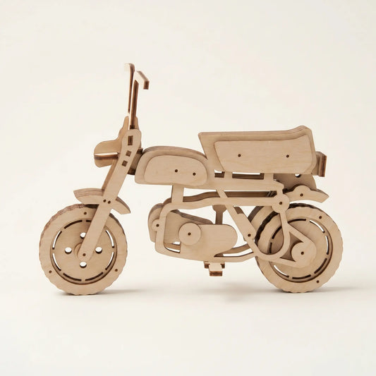 Wooden scooter motorcycle model on a beige background